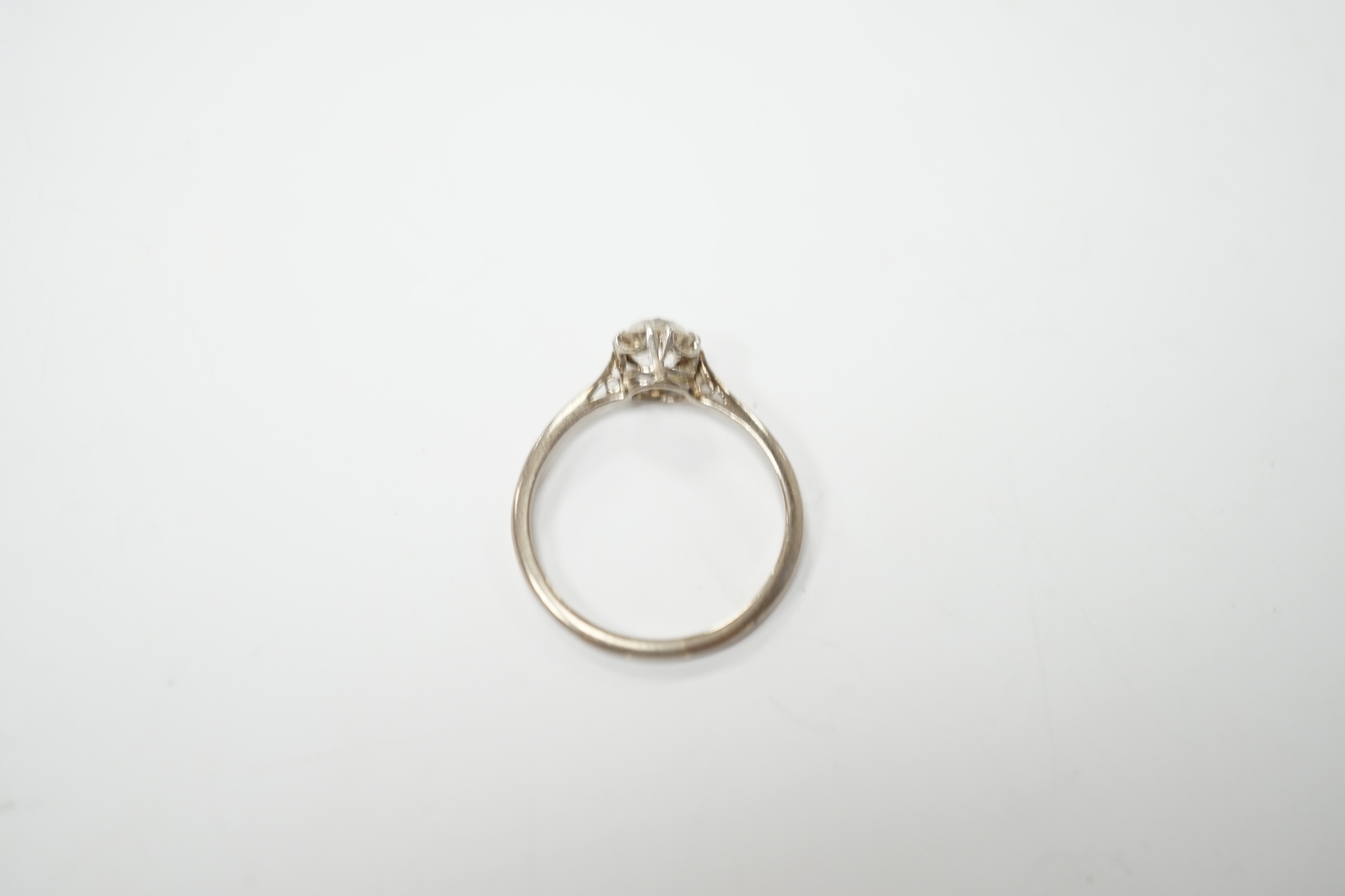 A white metal and solitaire diamond set ring, size O/P, gross weight 2.4 grams